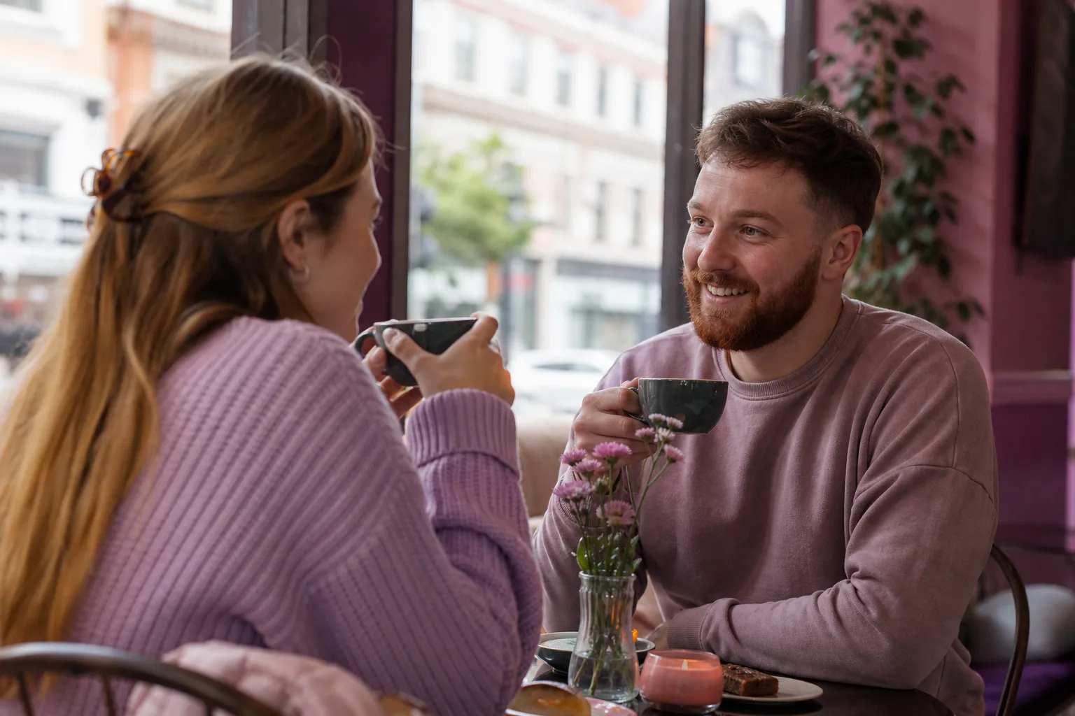 Two people talking over coffee in Belfast city centre