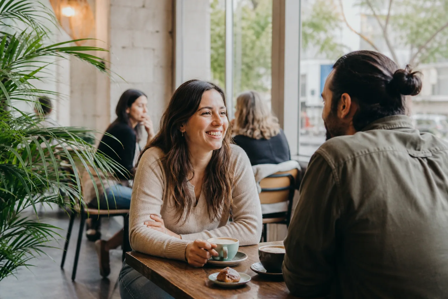 Two people talking over coffee in Belfast city centre